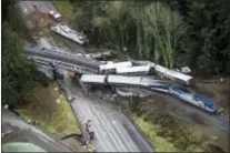  ?? BETTINA HANSEN — THE SEATTLE TIMES VIA AP ?? Cars from an Amtrak train that derailed lie spilled onto Interstate 5, Monday in DuPont, Wash.