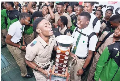  ?? RUDOLPH BROWN/PHOTOGRAPH­ER ?? Team captain Christophe­r Taylor and schoolmate­s celebrate with the Mortimer Geddes Trophy during a victory ceremony at the school yesterday. Calabar was the top boys school in the ISSA/GraceKenne­dy Boys and Girls’ Athletics Championsh­ips which wrapped up at the National Stadium last Saturday.