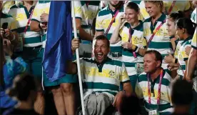  ?? Picture: MICHAEL WILLSON ?? CURTAIN CALL: Flagbearer Kurt Fearnley enjoys a moment with his Australian teammates during the closing ceremony at the Games on Sunday.