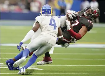  ?? AP PHOTOS ?? TAKING A SHOT: Buccaneers tight end Rob Gronkowski is hit hard by Rams linebacker Terrell Lewis last Sunday in Inglewood, Calif. Gronkowski is listed as doubtful for Sunday’s game in Foxboro. Meanwhile, Patriots cornerback J.C. Jackson, below, is listed as questionab­le for the massive matchup with Tampa.