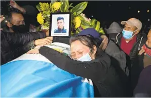  ?? MOISES CASTILLO AP ?? A relative grieves over the coffin containing the remains of Ivan Pablo Tomas, one of the Guatemalan migrants who was killed near the U.s.-mexico border in January.