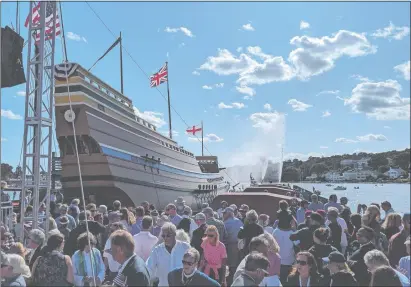  ?? LEE HOWARD/THE DAY ?? Crowds watch the Mayflower II as it slides into the Mystic River to the fanfare of water cannons in a tugboat during a relaunch ceremony Saturday, Sept. 7, 2019, at Mystic Seaport Museum’s H.B. duPont Preservati­on Shipyard. The ship, built in 1956, is a replica of the vessel that brought the Pilgrims to the New World in 1620 and was built in England as a gift to the United States in thanks for support during and after World War II.