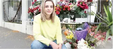  ?? Reuters ?? ↑
Aya Al Umari, sister of mosque attack victim Hussein Al Umari, poses outside Al Noor Mosque in Christchur­ch on Sunday.