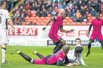  ??  ?? William Edjenguele stabs home a rebound to make it 2-0 to United.