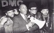  ?? PETER CANNATA/ASSOCIATED PRESS ?? Joe Clark, principal of Eastside High School in Paterson, N.J., stands with rap group Run-DMC before the group gave a concert at the school in February 1988.