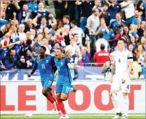  ?? THOMAS SAMSON/AFP ?? France forward Ousmane Dembele (left) celebrates with teammate Kylian Mbappe after scoring in their friendly with England at Stade de France on Tuesday.