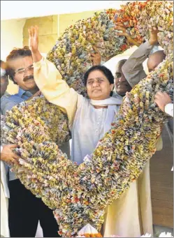  ??  ?? ■ Bahujan Samaj Party (BSP) supremo Mayawati with a garland made of currency notes by her party cadre at the BSP headquarte­rs in Lucknow. HT FILE PHOTO