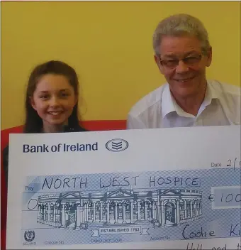  ??  ?? Ten year old Codie Kilgannon pictured presenting Dr Nigel McCarley of the North West Hospice with a cheque for € 1,000, proceeds of her Junior Hell and Back challenge.