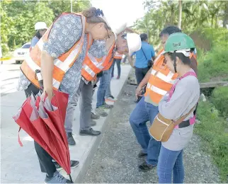  ??  ?? FRAUKE JUNGBLUTH, World Bank task team leader for the Philippine Rural Developmen­t Project, leads the site visit of the road concreting in Mainit, Surigao del Norte, which covers 18.4 kilometers and is expected to benefit 1,994 farming households.