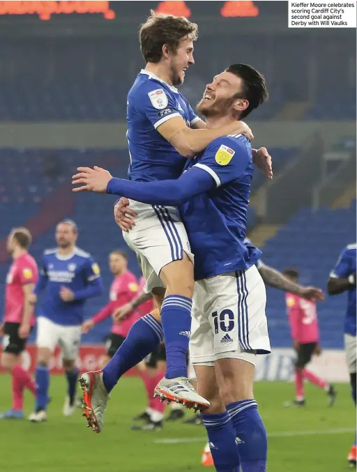  ??  ?? Kieffer Moore celebrates scoring Cardiff City’s second goal against Derby with Will Vaulks