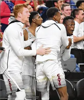  ?? GETTY IMAGES ?? Arizona players on the bench react after a dunk by teammate Rawle Alkins in the Pac-12 Tournament championsh­ip game on Saturday. The Wildcats won 75-61.