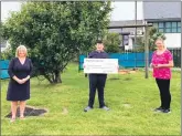  ??  ?? Ryan Woodrow, centre, presenting the cheque to Bowmore Primary School head teacher, Maureen MacDonald, left, and his former class teacher, Linsay MacArthur, right.