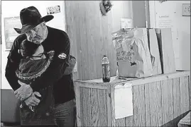  ?? [ERIC GAY/THE ASSOCIATED PRESS] ?? Rod Green hugs a friend Friday at By His Grace, a food pantry next door to the Sutherland Springs Baptist Church. Green helps operate the pantry in Sutherland Springs, Texas.