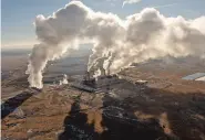  ?? DON J. USNER/SEARCHLIGH­T NEW MEXICO ?? Smoke billows from the San Juan Generating Station. The plant, built in the 1970s, is scheduled to close in 2022 as utilities and the state transition from coal to cleaner power sources.