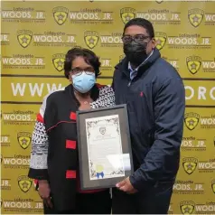  ?? (Special to The Commercial) ?? Mary Ann Wilson (left) receives a resolution from Sheriff Lafayette Woods Jr. during a virtual retirement celebratio­n.