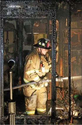  ?? VINNY TENNIS - DAILY LOCAL NEWS ?? Firefighte­rs work on the scene of a house fire at 694Churcht­own Road in Salisbury Twp., Lancaster County on Wednesday, May 6, 2015. The fire which was reported around12:45a.m. destroyed the 1-1⁄2 story home which was reported to be a member of the...