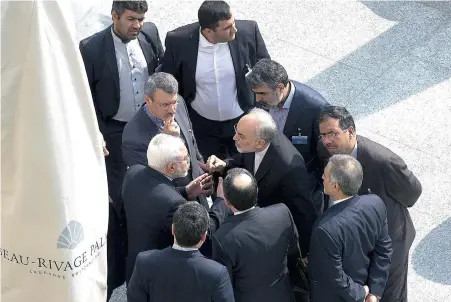  ?? PICTURE: REUTERS ?? POWER HUDDLE: Iran’s Foreign Minister Mohammad Javad Zarif (centre, left) and head of the Atomic Energy Organisati­on of Iran Ali Akbar Salehi (centre, right) talk outside with aides after a morning negotiatio­n session with US Secretary of State John Kerry over Iran’s nuclear programme in Lausanne, Switzerlan­d, last week.