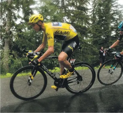  ??  ?? Froome defending his yellow jersey in yesterday’s rainy stage