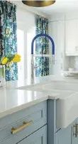  ??  ?? A Grohe Essence Semi-Pro singlehand­le faucet with a blue hose picks up the colour in the curtains in this kitchen. CHRISTINE ELLIOTT