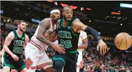  ?? CHRIS SWEDA/CHICAGO TRIBUNE ?? Celtics forward Xavier Tillman and Bulls forward Torrey Craig battle for a loose ball in the first half Saturday at the United Center.