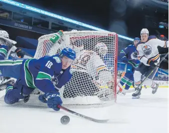  ?? DARRYL DYCK, THE CANADIAN PRESS ?? Jake Virtanen falls behind the net during a Vancouver Canucks NHL game against the Edmonton Oilers in 2021. Virtanen, who is no longer with the Canucks, was charged with one count of sexual assault in January following a police investigat­ion that began in 2017.