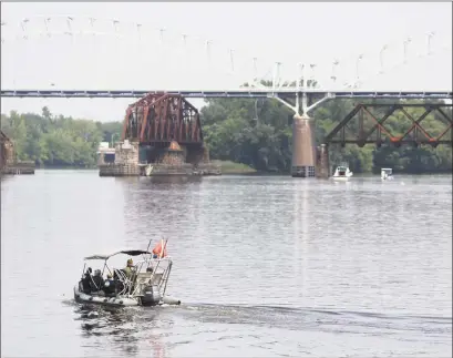  ?? Lauren Schneiderm­an/The Hartford Courant via AP ?? Authoritie­s search the Connecticu­t River near the Arrigoni Bridge for a missing child July 6, 2015, in Middletown. Tony Moreno was convicted of killing his 7-month-old son by throwing him from the bridge.