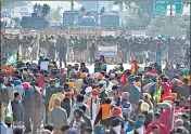  ??  ?? Police block a street to impede farmers from marching to New Delhi to protest against the agricultur­al reforms at the DelhiHarya­na border in Kundli on Friday.