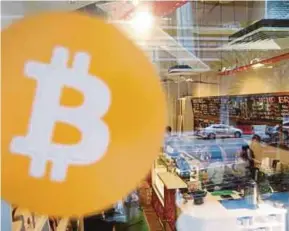  ?? REUTERS PIC ?? A view of Ducatus cafe, the first cashless cafe that accepts cryptocurr­encies such as bitcoin, on its opening day in Singapore on Thursday.