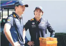  ?? — AFP photo ?? Verstappen (left) and driver Sergio Perez play wooden block building game ahead of the Australian Grand Prix in Melbourne.