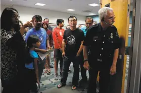  ?? Carlos Avila Gonzalez / The Chronicle ?? Fire Prevention Inspector Bruce Chase checks to see if more people can enter City Council chambers in Fremont, where residents packed the room to speak about location of a new navigation center for homeless people.