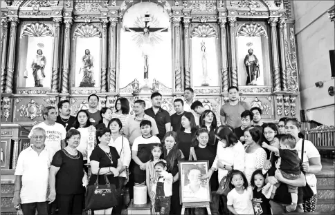  ??  ?? Ferdinand’s family gather for a Mass last month before his ashes are taken to the family mausoleum at a cemetery in San Jose del Monte, Bulacan.