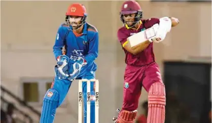  ??  ?? GROS ISLET: Shai Hope (R) of West Indies hits 4 during the 2nd ODI match between West Indies and Afghanista­n at Darren Sammy National Cricket Stadium, Gros Islet, St Lucia, Sunday. — AFP