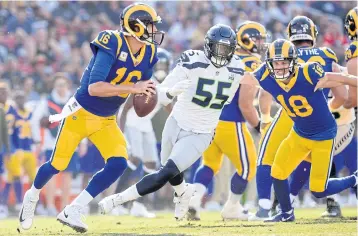  ?? USA TODAY SPORTS ?? Rams quarterbac­k Jared Goff, left, rolls out to pass against the Seahawks in Los Angeles.