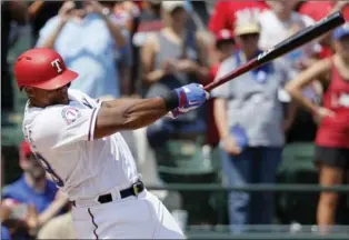  ?? TONY GUTIERREZ, THE ASSOCIATED PRESS ?? Rangers’ Adrian Beltre follows through on a double for his 3,000th career hit that came off of a pitch from Baltimore Orioles’ Wade Miley, who later applauded the hitting great’s accomplish­ment.