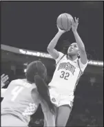  ?? Associated Press ?? Ohio State forward Cotie McMahon (32) shoots over Tennessee guard Jordan Walker (4) during the second half on Tuesday in Columbus, Ohio. No. 14 Ohio State beat No. 5 Tennessee 87-75.