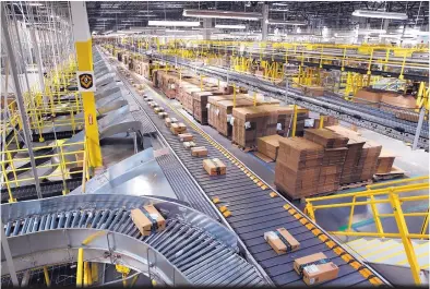  ?? PATRICK SEMANSKY/ASSOCIATED PRESS ?? Packages ride on a conveyor system at an Amazon fulfillmen­t center in August 2017. The online retailer’s muchhyped Prime Day shopping holiday got off to a rocky start Monday, but many of the problems cleared up later.