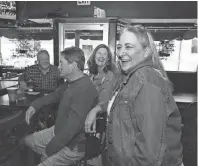  ?? ?? Owner Cathy Zachari shares a laugh with some regular patrons. She started working at Come Back Inn as a server in 2001 and then took over the business in 2012.