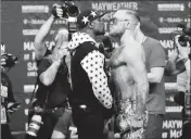  ?? ASSOCIATED PRESS ?? THIS JULY 13 PHOTO SHOWS Floyd Mayweather Jr. (left) and Conor McGregor, of Ireland, facing each other for photos during a news conference at Barclays Center in New York.