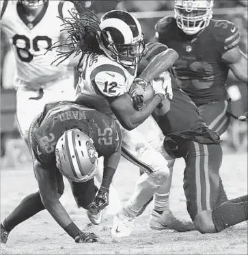  ?? Marcio Jose Sanchez Associated Press ?? RAMS RECEIVER Sammy Watkins (12) gets between San Francisco cornerback Jimmie Ward, left, and defensive back Dontae Johnson to score a touchdown during the second half of their game Thursday.