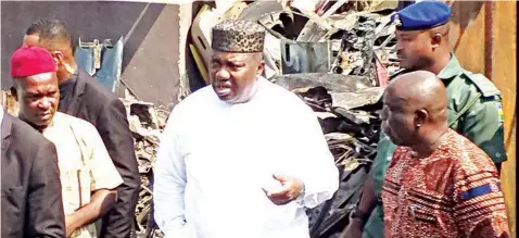  ??  ?? Enugu State Governor, Rt. Hon. Ifeanyi Ugwuanyi (middle), with Chairman, Enugu North Local Government Area, Hon. Emma Onoh (right) and the Chairman, Tinker Motor Spare Parts Market, Coal Camp, Enugu, Chief Crescent Ugwuoke, during the Governor’s visit to the scene of the market’s fire incident, to empathise with traders, yesterday.