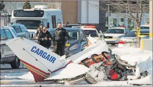  ?? CP PHOTO ?? First responders look over the wreckage after two small planes collided and crashed Friday in Saint Bruno, Que. One person was killed and three people were injured.