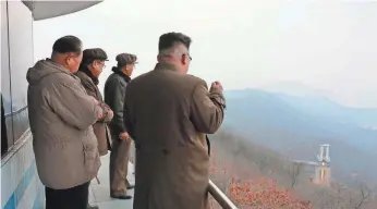  ?? KOREAN CENTRAL NEWS AGENCY VIA AFP/GETTY IMAGES ?? This undated picture released Sunday shows North Korean leader Kim Jong Un, right, watching the ground jet test of a high-thrust engine at the Sohae Satellite Launching Ground in North Korea.