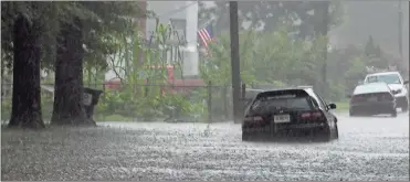  ?? / Kevin Myrick ?? Above: Waters rose fast on Walnut Street in Cedartown on the afternoon of July 31. The storm threatened to flood a car parked along the street. Below: Cedar Creek ran over its banks on Tuesday afternoon, July 31 during a flash flood event. It was the...