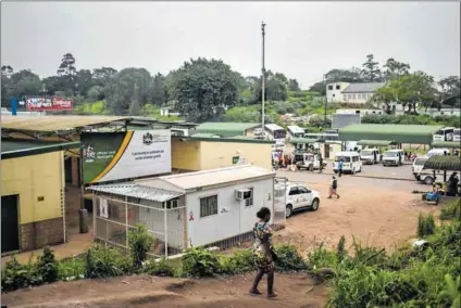  ??  ?? Progress: Nkosinathi Mpongose (left) and his colleague, Bongani Thethwayo, usher the men of Eshowe into the Philandoda clinic (above), which was once a storage container and is now a healthcare centre offering testing and treatment for HIV and other...