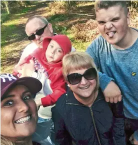  ??  ?? TORN APART: Carla Hodges, left, with stepdad Les, second left – who refused the vaccine and died of Covid – mum Amanda and children