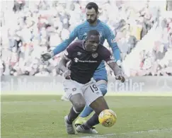  ??  ?? 0 Uche Ikpeazu goes down as his foot is trodden on by Aberdeen keeper Joe Lewis, but the Hearts striker was booked for ‘diving’.