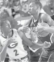  ?? JOSHUA L. JONES/AP ?? Florida forward Keith Stone, right, steals the ball from Georgia guard Jordan Harris during the Gators’ victory Saturday in Athens, Ga.