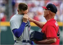  ?? BUTCH DILL — THE ASSOCIATED PRESS ?? Dodgers first baseman Freddie Freeman, left, tears up as he is presented with his World Series championsh­ip ring by Braves manager Brian Snitker Friday in Atlanta.