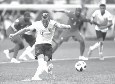  ?? Matthias Schrader/Associated Press ?? ■ England’s Harry Kane kicks a penalty to score his team’s second goal during the group G match between England and Panama on Sunday at the 2018 soccer World Cup at the Nizhny Novgorod Stadium in Nizhny Novgorod, Russia.