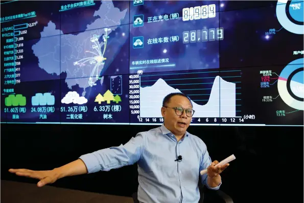  ?? NG HAN GUAN/AP FILES ?? Ding Xiaohua, deputy director of the Shanghai Electric Vehicle Public Data Collecting, Monitoring and Research Center, works with a data display screen in Shanghai. He says China’s electric vehicle monitoring program is not meant for state surveillan­ce, though he said data could be shared with government public security organs.